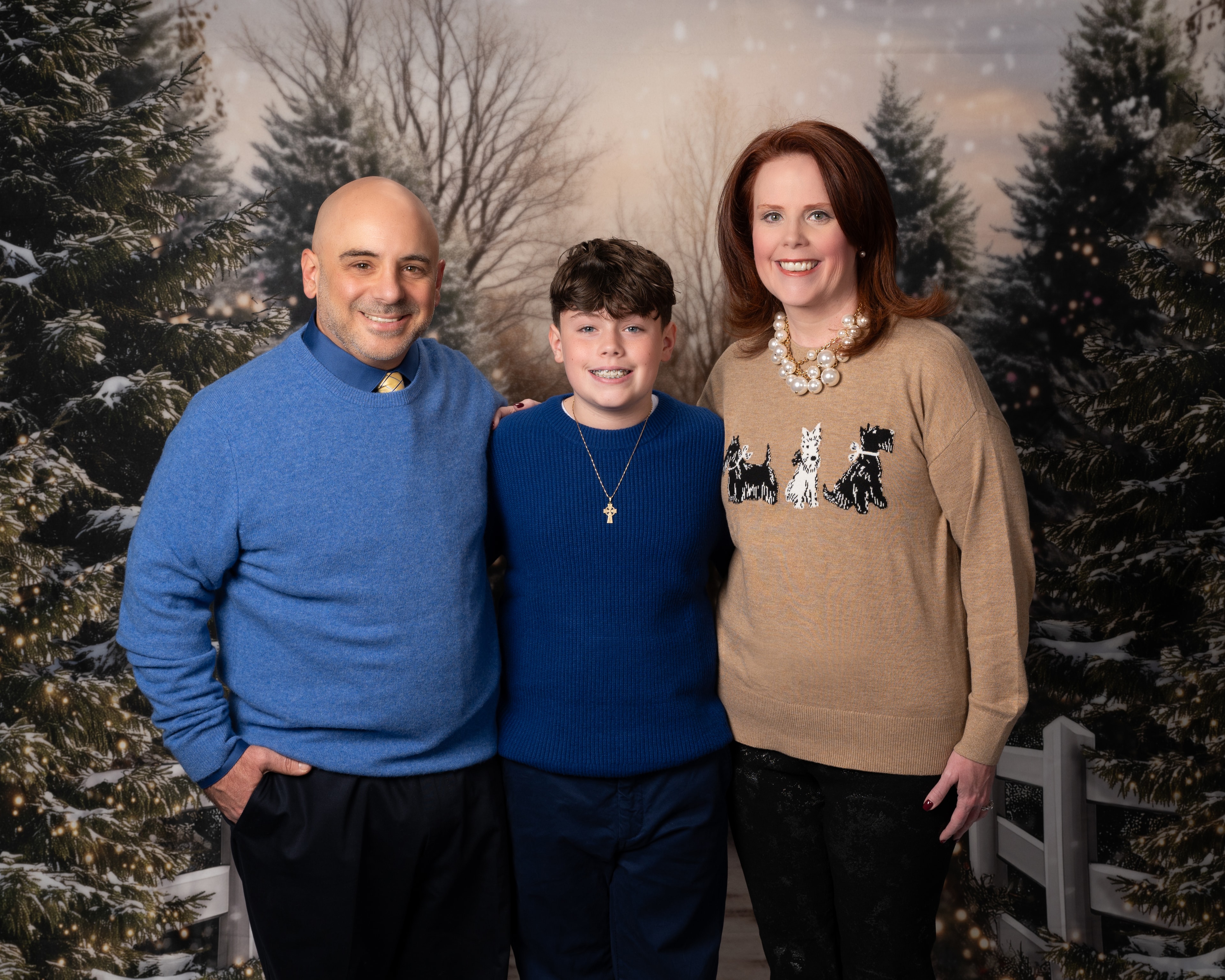 Family portrait in winter forest backdrop